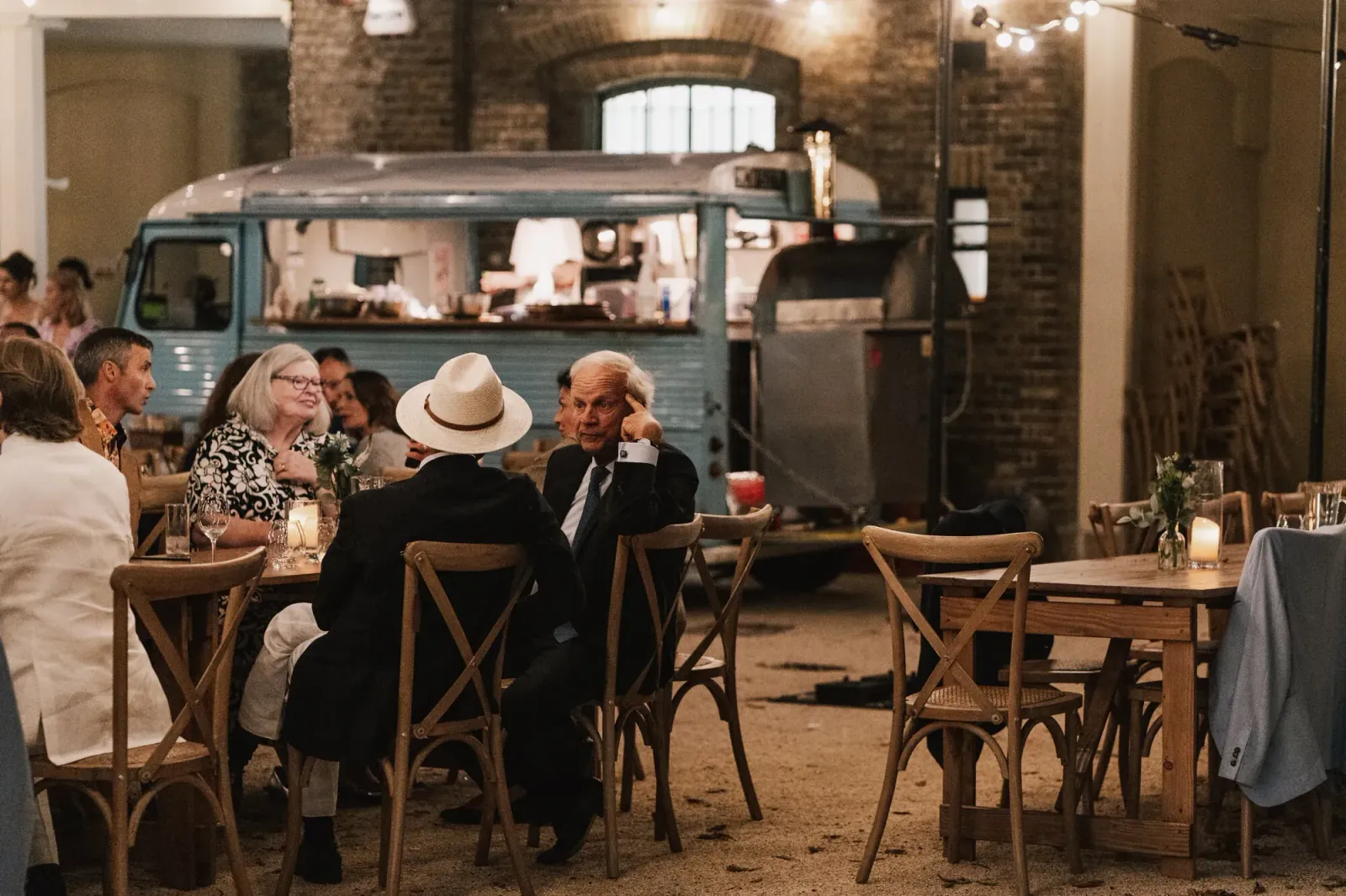 Guests eating beside a vintage food truck